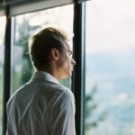 Exhausted founder reflecting alone in office during late night work session